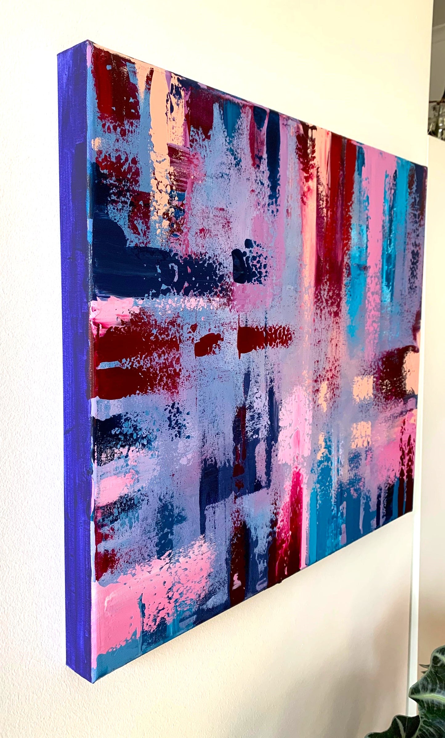 Close-up of textured abstract acrylic painting with purple and blue brushstrokes.