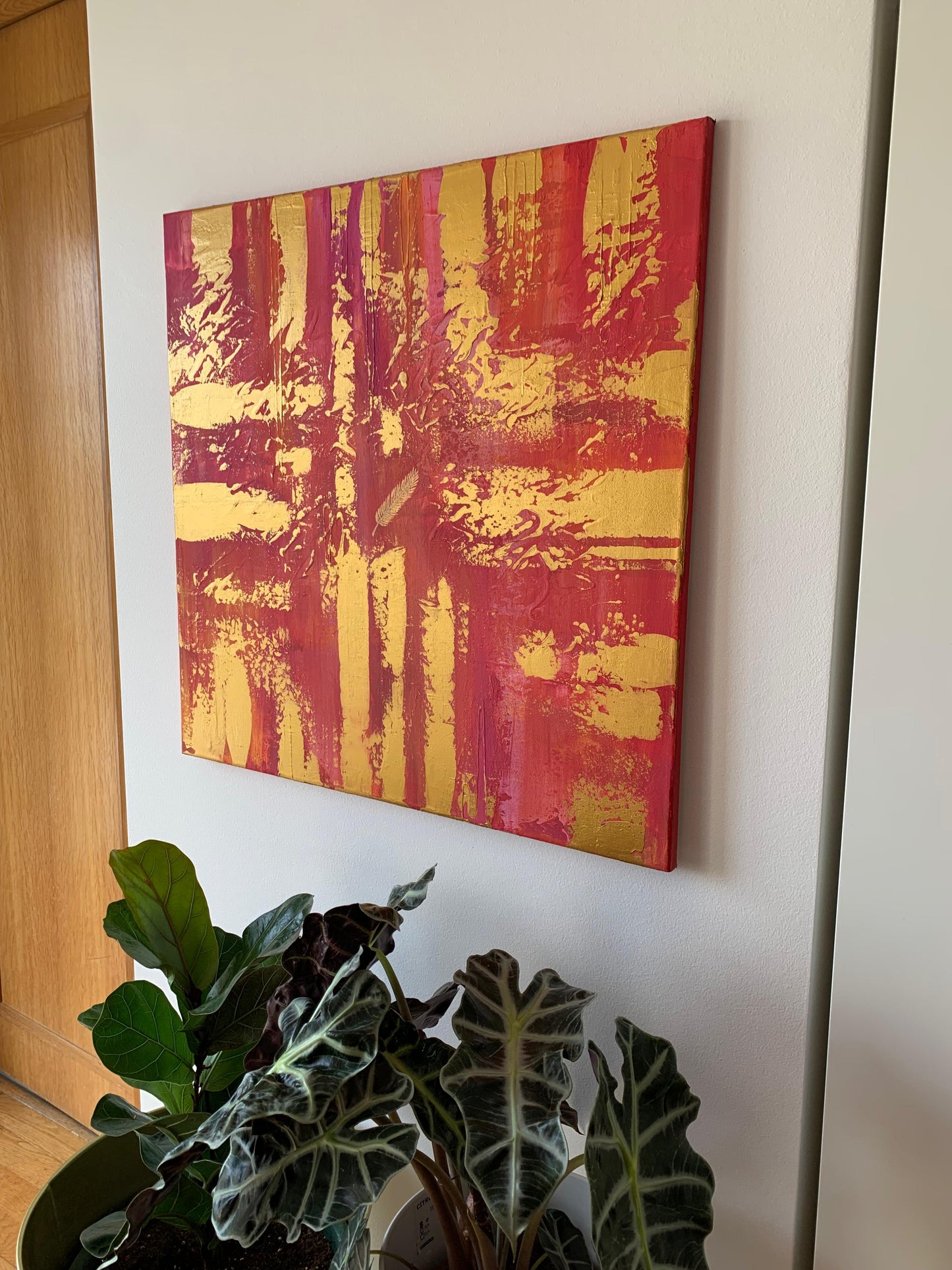Large abstract canvas with textured brushwork in bold golden hues.